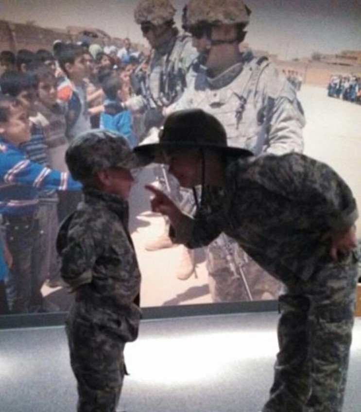 Two children dressed as soldiers exploring a military exhibit at the National Infantry Museum at Fort Benning, Georgia.