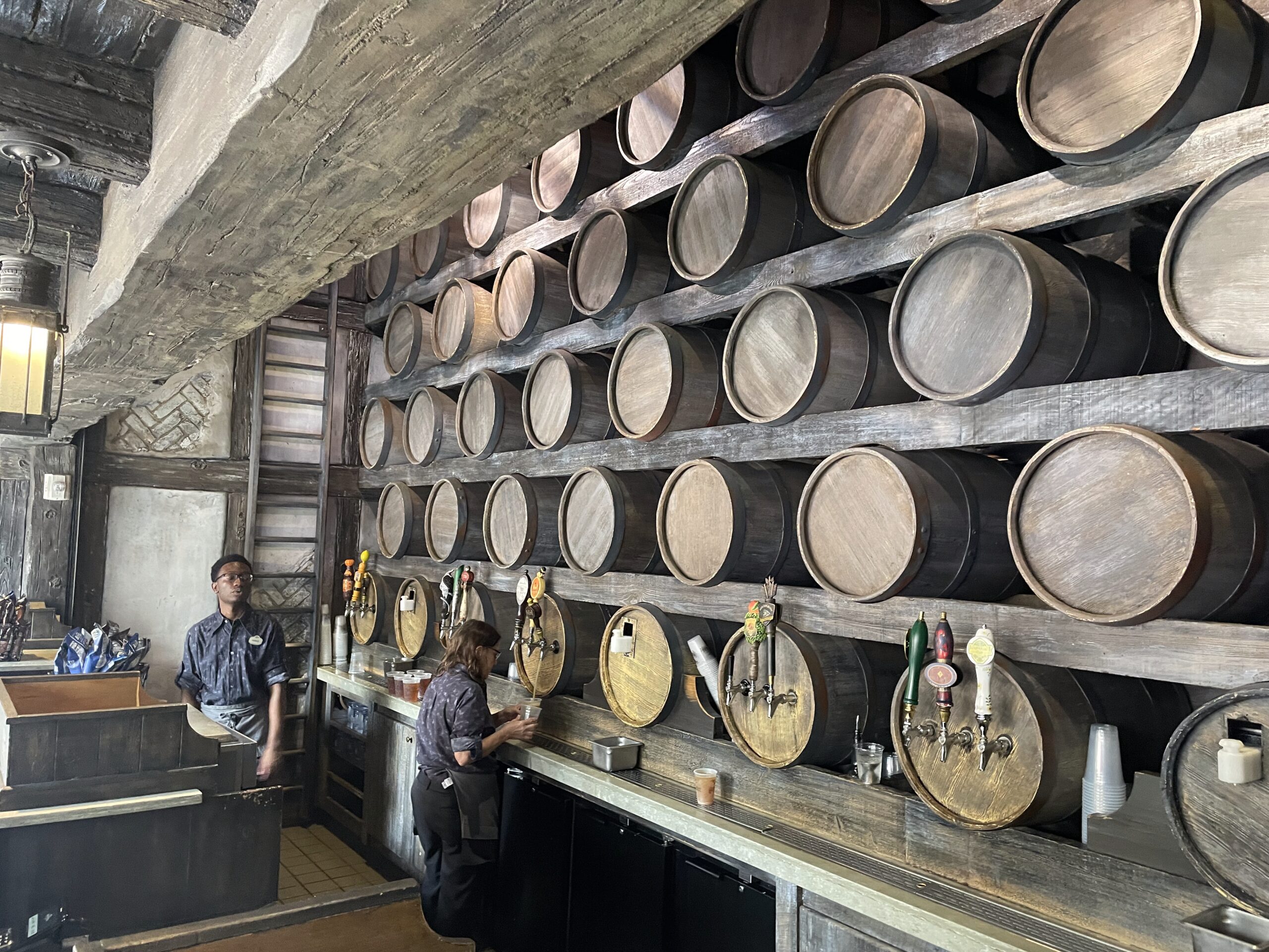 Close-up of the signature beer taps and kegs in Diagon Alley, highlighting the unique craft beer offerings available to adults at Universal Studios Florida's Wizarding World.