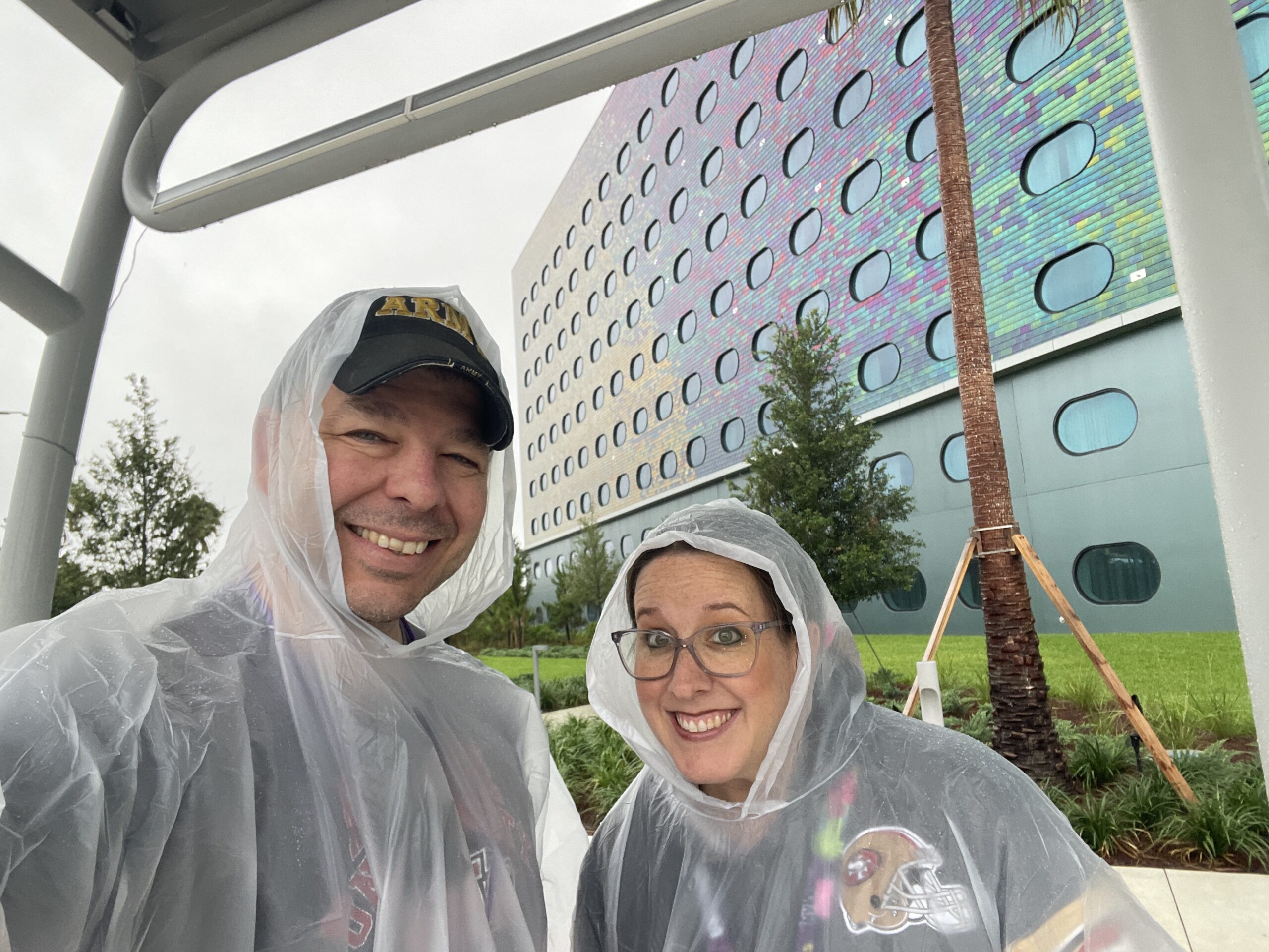 Travel agents Alan and Katy Thompson in Orlando at Universal Studios Orlando in ponchos in the rain.