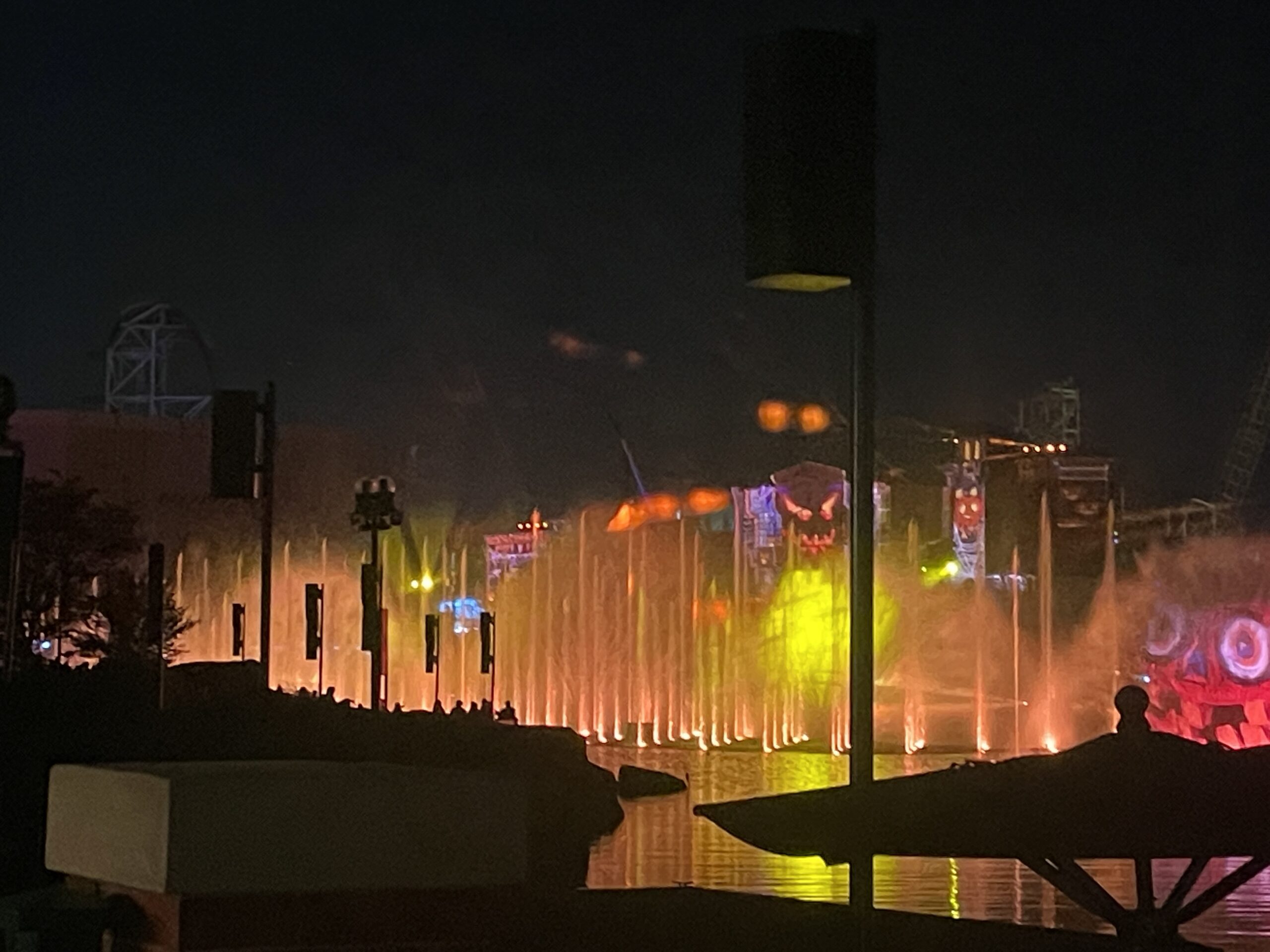 A night time photo of the fountains display at HHN in Universal Studios Orlando