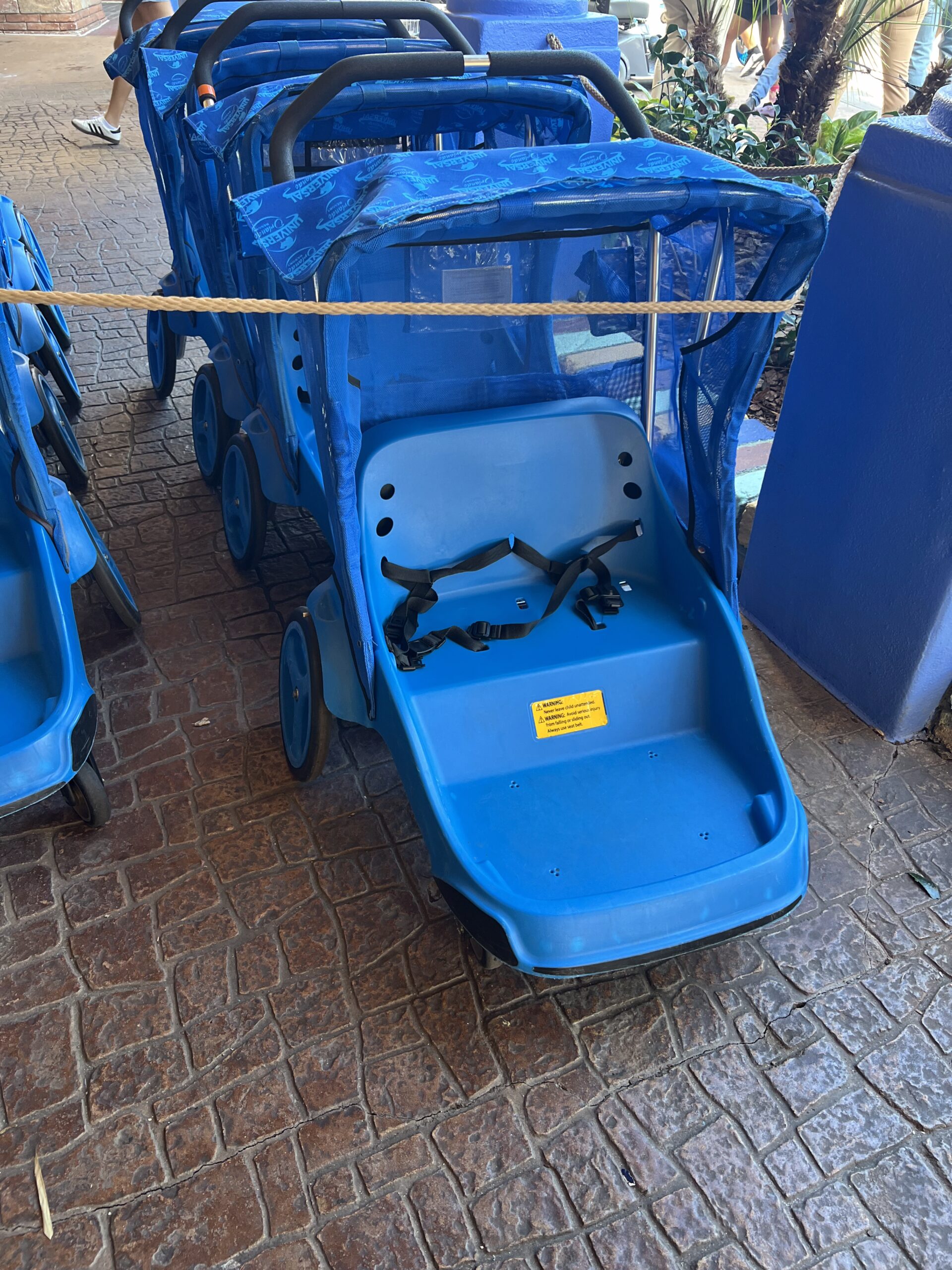 A high-quality rental stroller used at Universal Orlando to prevent toddler fatigue during a long day at the theme parks.