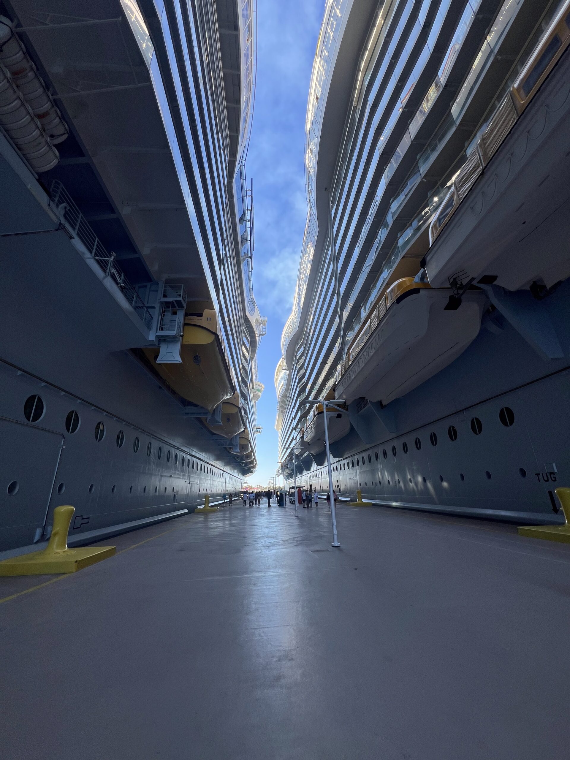 Standing between 2 Royal Caribbean Cruise ships on the dock in the Bahamas.