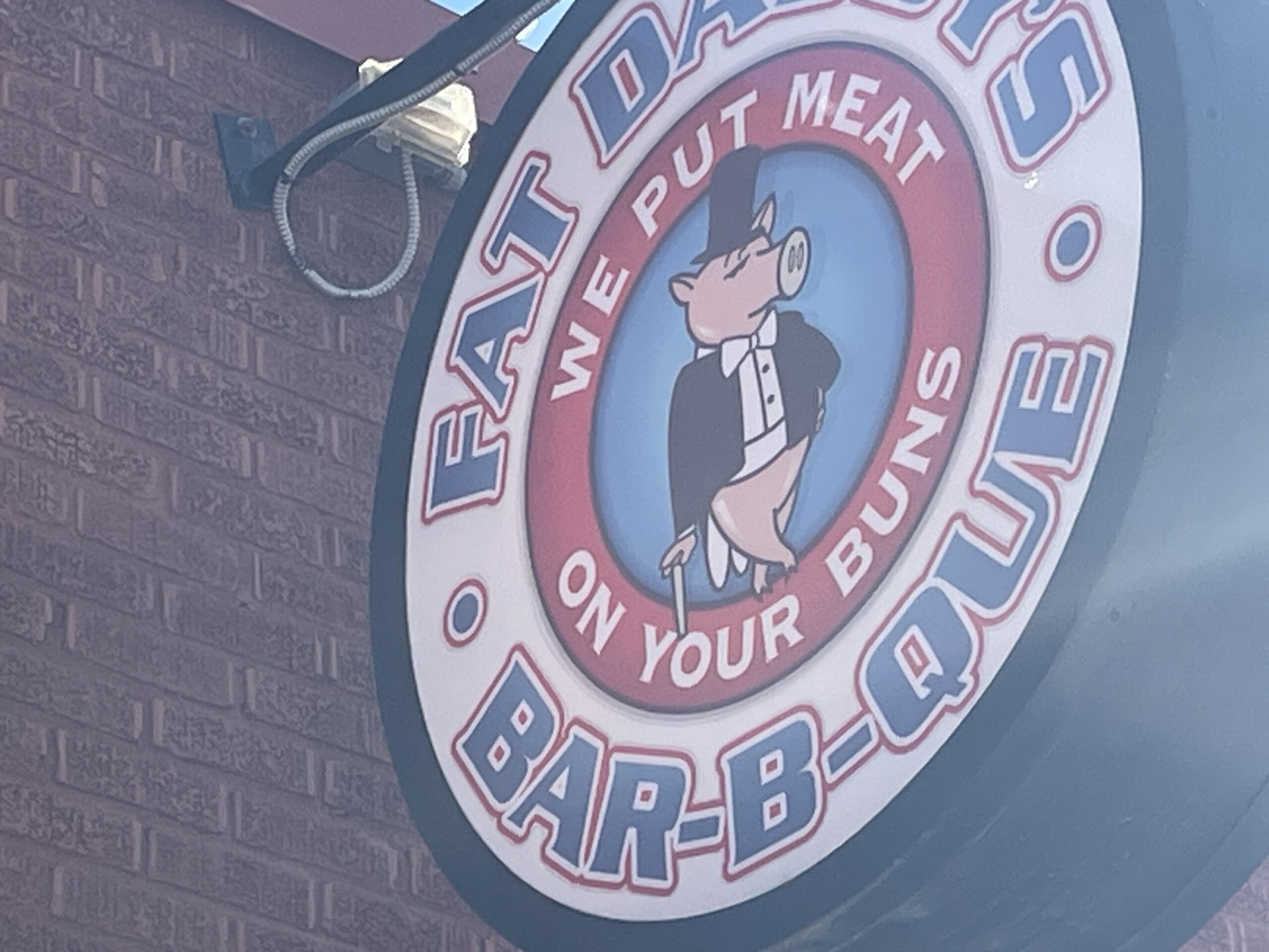 Exterior view of Fat Daddy's Bar-b-ue sign.