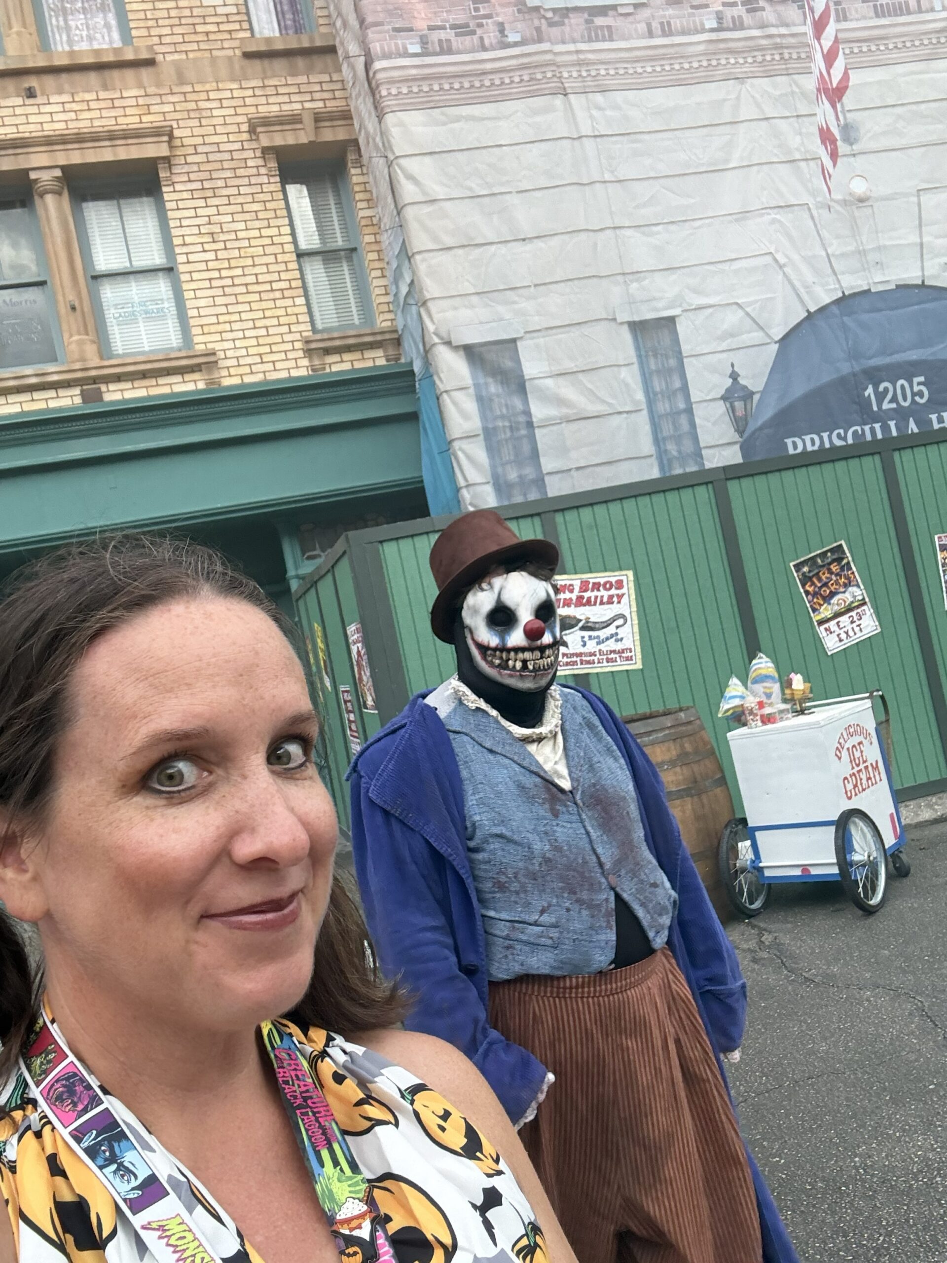 Halloween Horror Night expert and professional travel agent, Katy Thompson of Gallivanters Vacations, in a scare zone with a clown at HHN 35 at Universal Studios, Orlando FL.